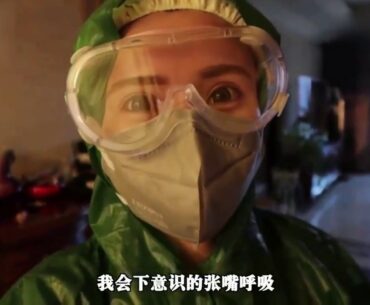 A Chinese woman is wearing rainwear & N95 mask & vinyl gloves & goggles