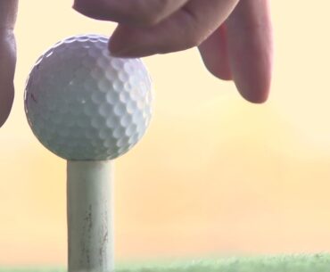 placing ball on golf tee slow motion