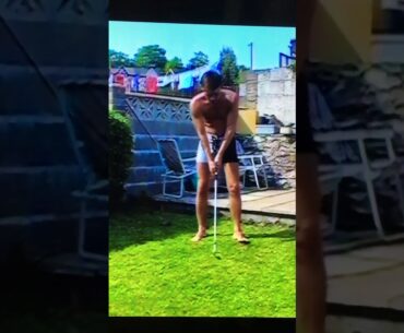 Dad doing a golf swing, in his back garden where he grew up in Wales. 1993