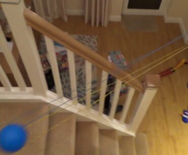 Homemade MARBLE RUN using telephone wire, plastic golf ball and a domino set.