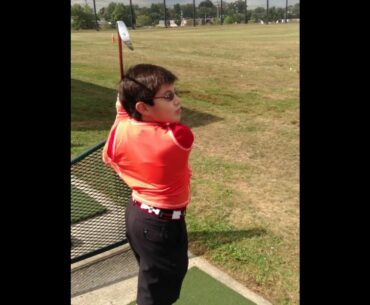 10 year old junior golfer practices with The Golf Swing Shirt.