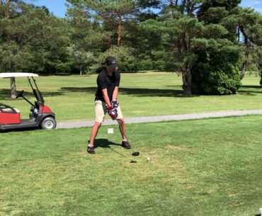 Rylan Iwachniuk golfing with hockey gloves on at the Cornwall Colts Jr A charity golf tournament