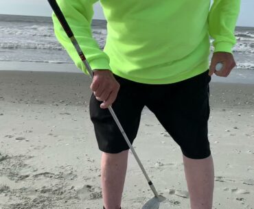 Hitting golf ball into Atlantic Ocean