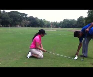 lady playing golf while kneeling down.MOV