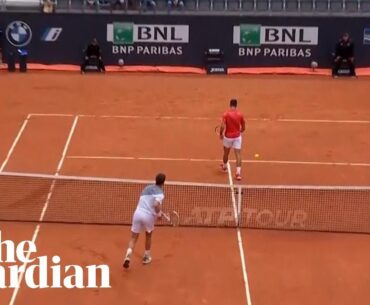Cameron Norrie smashes ball into Novak Djokovic's legs as world No 1 turns back on net