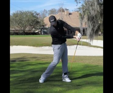 Pulling the club down the target line in the golf swing