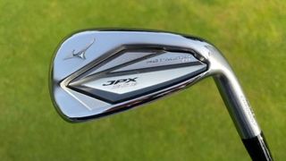 Mizuno JPX923 Hot Metal HL Iron held aloft on the golf course